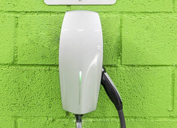 charger for electric vehicles on a green wall